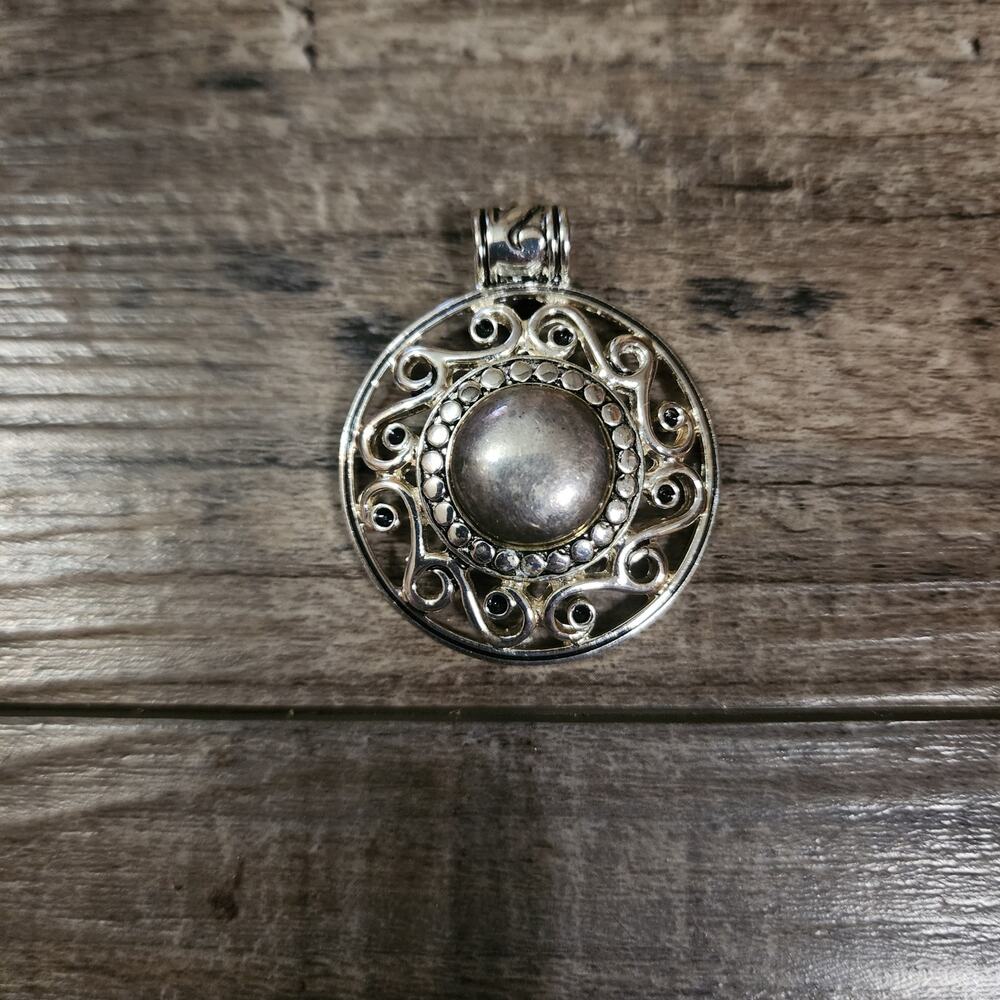 Silver colored pendant from RMN